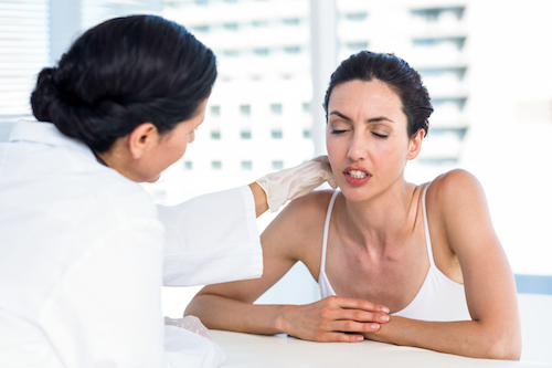 Woman at the doctor with neck pain
